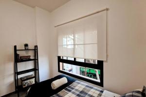a bedroom with a window with a window shade at Acacias Home Arrecife in Arrecife