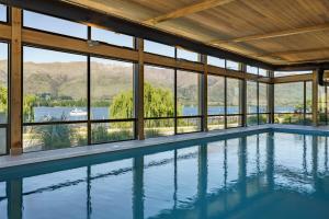 a swimming pool in a house with a view of the water at Marina Terrace, Wanaka in Wanaka