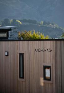 una señal en el lateral de un edificio con dos ventanas en Marina Terrace, Wanaka, en Wanaka