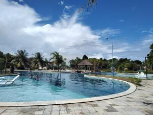 una gran piscina con gente en el agua en Flat no loa Resort & Residence, en Barra de São Miguel
