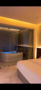 a bedroom with two beds and a glass wall at شاليهات درة بارك الشقيق in Ash Shuqayq