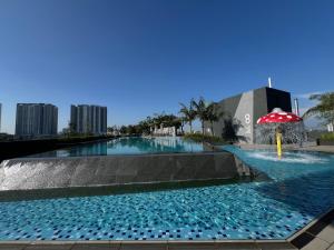 a swimming pool with a fountain in the middle of a city at Homely Haven in Kajang 21-09 in Kajang