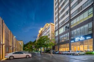 a row of cars parked in front of a building at Phoenix Hill Hotel Dongguan - Golf Course Shop in Tiantangwei