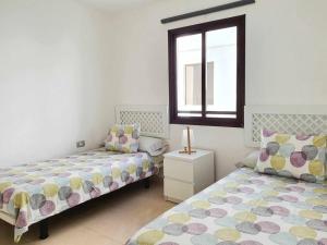 1 Schlafzimmer mit 2 Betten und einem Fenster in der Unterkunft El Reducto Suite in Arrecife