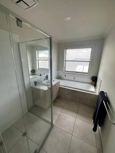 a bathroom with a glass shower and a sink at Coastal Oasis - 10 mins to Torquay, 10 mins to Geelong ! in Mount Duneed