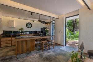 an open kitchen with a counter and stools at Daya Villa in Kampot