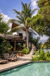 a villa with a swimming pool and a house at Daya Villa in Kampot