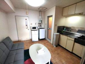a small kitchen with a table and a white counter top at E-Horizon北2条 in Sapporo