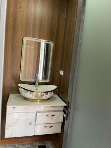 a bathroom with a sink and a mirror at Khách sạn - Nhà hàng Hoàng Phúc in Tuy Phong