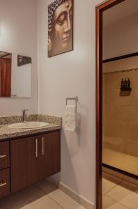 a bathroom with a sink and a shower at Private home with resort style swimming pool in Jacó