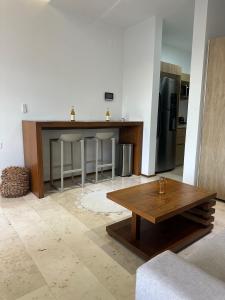 a kitchen with a wooden table and a refrigerator at Smart Home Luxury Condo 5ta avenida in Playa del Carmen