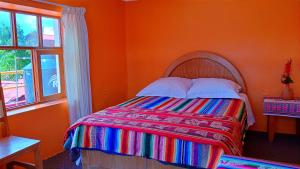 Ένα ή περισσότερα κρεβάτια σε δωμάτιο στο Amantani Samary Lodge