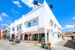 a white building on the side of a street at Nexus Hotel in Melaka