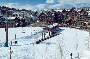 a ski resort with a ski lift in the snow at Ritz-Carlton Bachelor Gulch in Avon