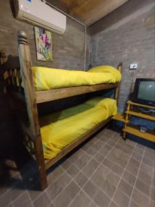 two bunk beds in a room with a tv at Ranchouse in San Rafael
