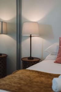 a lamp sitting on a table next to a bed at Perfect Located 1-Bed with Great Views & Parking in Kingston 
