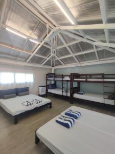 two beds in a room with bunk beds in it at Caliraya Mountain Lake Resort in Cavinti