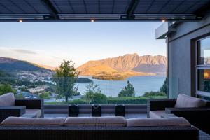 a large window with a view of a lake and mountains at Lordens Apartment 1 in Queenstown