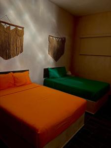 two beds in a room with green and orange at Casa Fausto’s in Azcorra