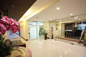 a lobby with a store with pink flowers in it at TM Land Hotel in Phra Nakhon Si Ayutthaya