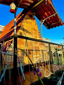 a swing in front of a wooden house at Airport Traveler's home. in Alajuela City