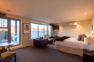 a bedroom with a bed and a living room at Lordens Apartment 1 in Queenstown