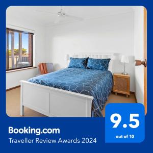 um quarto com uma cama com um edredão azul em Amazing Ocean Views At This Exclusive 4 BR Holiday Home em McCracken
