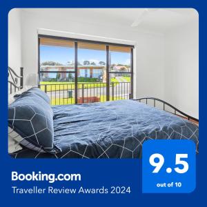 1 cama en un dormitorio con ventana grande en Amazing Ocean Views At This Exclusive 4 BR Holiday Home, en McCracken