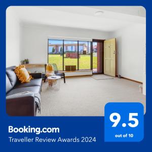 sala de estar con sofá y ventana grande en Amazing Ocean Views At This Exclusive 4 BR Holiday Home, en McCracken