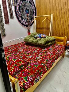 a bedroom with a bed with a red blanket at AKa HomeStay in Yên Minh