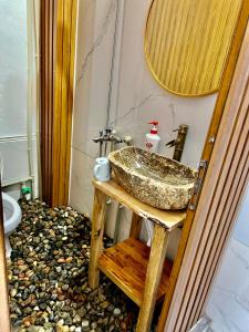 a bathroom with a sink on a wooden table at AKa HomeStay in Yên Minh