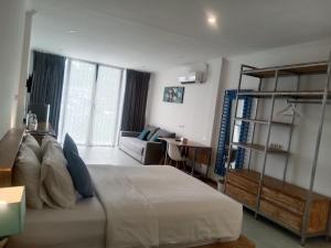 a bedroom with a bed and a living room at Triple 8 Suites in Labuan Bajo