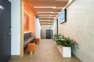 a hallway of an office with benches and plants at 75-2A furnished 1BR W D Elev central park in New York