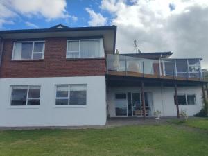 オークランドにあるPerfect living in Easternの側面にデッキがある家 +3枚の写真