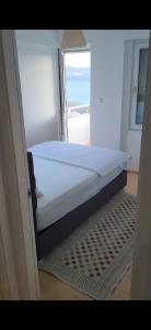 a large bed in a room with a window at Rüyakent Sea Panorama in Didim
