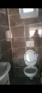 een badkamer met een wit toilet en een wastafel bij Rüyakent Sea Panorama in Didim