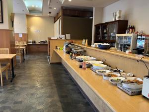 a buffet line in a restaurant with food on it at Hotel Alpha-One Niigata in Niigata