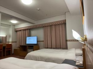 Postel nebo postele na pokoji v ubytování Hotel Alpha-One Niigata + 1 fotografie