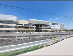 a large building with a parking lot in front of it at Luxury Homes in Nairobi in Athi River
