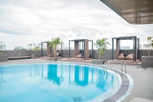 a swimming pool on top of a building at Tavia Heritage Hotel in Jakarta