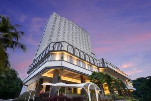 a large white building with a lot of windows at Tavia Heritage Hotel in Jakarta
