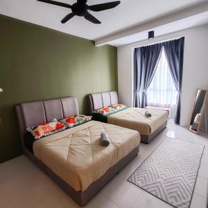 a bedroom with two beds and a ceiling fan at D'Elegant Suite - Emerald Avenue in Cameron Highlands