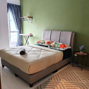 a bed with two pillows on it in a bedroom at D'Elegant Suite - Emerald Avenue in Cameron Highlands