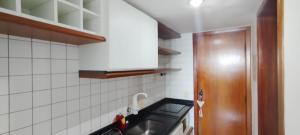 a kitchen with a sink and a counter top at Hotel sol vitória Marina in Salvador