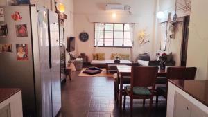 a dining room and living room with a table and chairs at The Patnem villa in Canacona