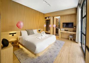 a bedroom with a bed with a pink balloon on it at Akaya Villas Solo in Kemiri