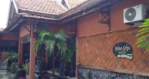 a restaurant with a sign on the side of a building at Griya Istana 1 in Solo