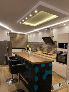 a kitchen with a large island in the middle at Joli Duplex in Amilcar