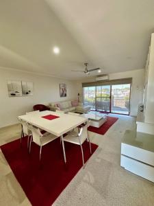 a living room with a table and a couch at Mariners Cove at Paynesville in Paynesville