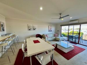 a living room with a table and a couch at Mariners Cove at Paynesville in Paynesville